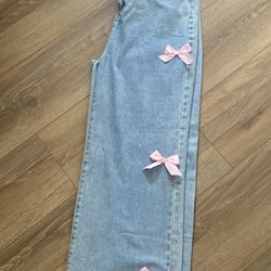 Medium size blue jeans w/ pink bow