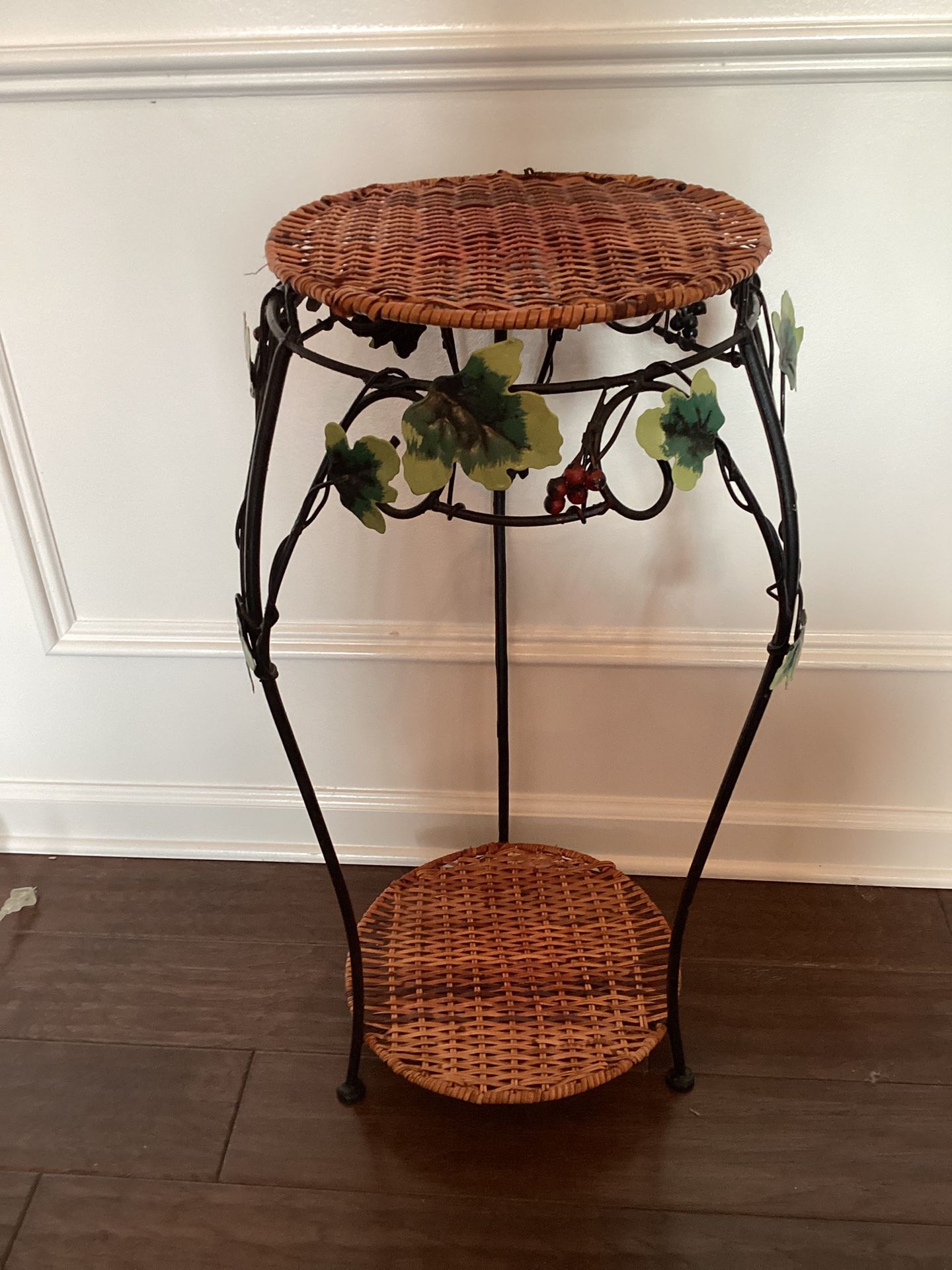 Decorative plant stand w/ 2 wicker shelves, metal frame featuring leaf accents 28” T x 12W