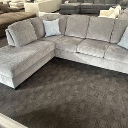 Light Gray Modern Sectional With Sky Blue Accent Pillows 