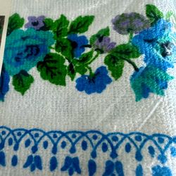 Vintage Tastemaker by Stevens fashion Terry  tablecloth 52“ x 70“. New in pkg unused. blue, turquoise and purple florals with greenery on a white back