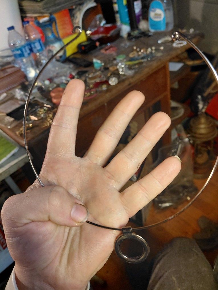 vintage silver-tone choker necklace with a circular pendant. 