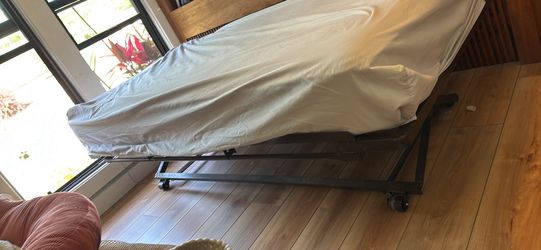 Twin mattress and pop up roll trundle frame