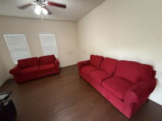 RED COUCH AND LOVE SEAT WITH PULL OUT BED