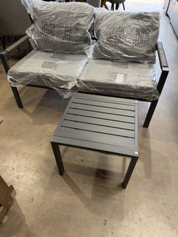 Gray bench with coffee table and cushions