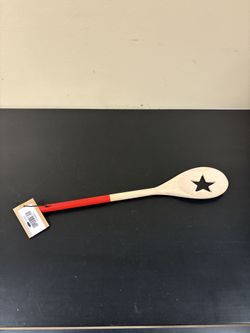acacia wood spoon with cut oil and a star design
