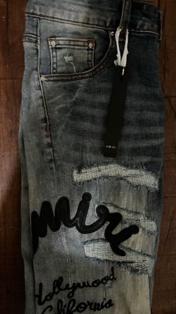 Amiri Distressed Denim Jeans with Script Embroidery