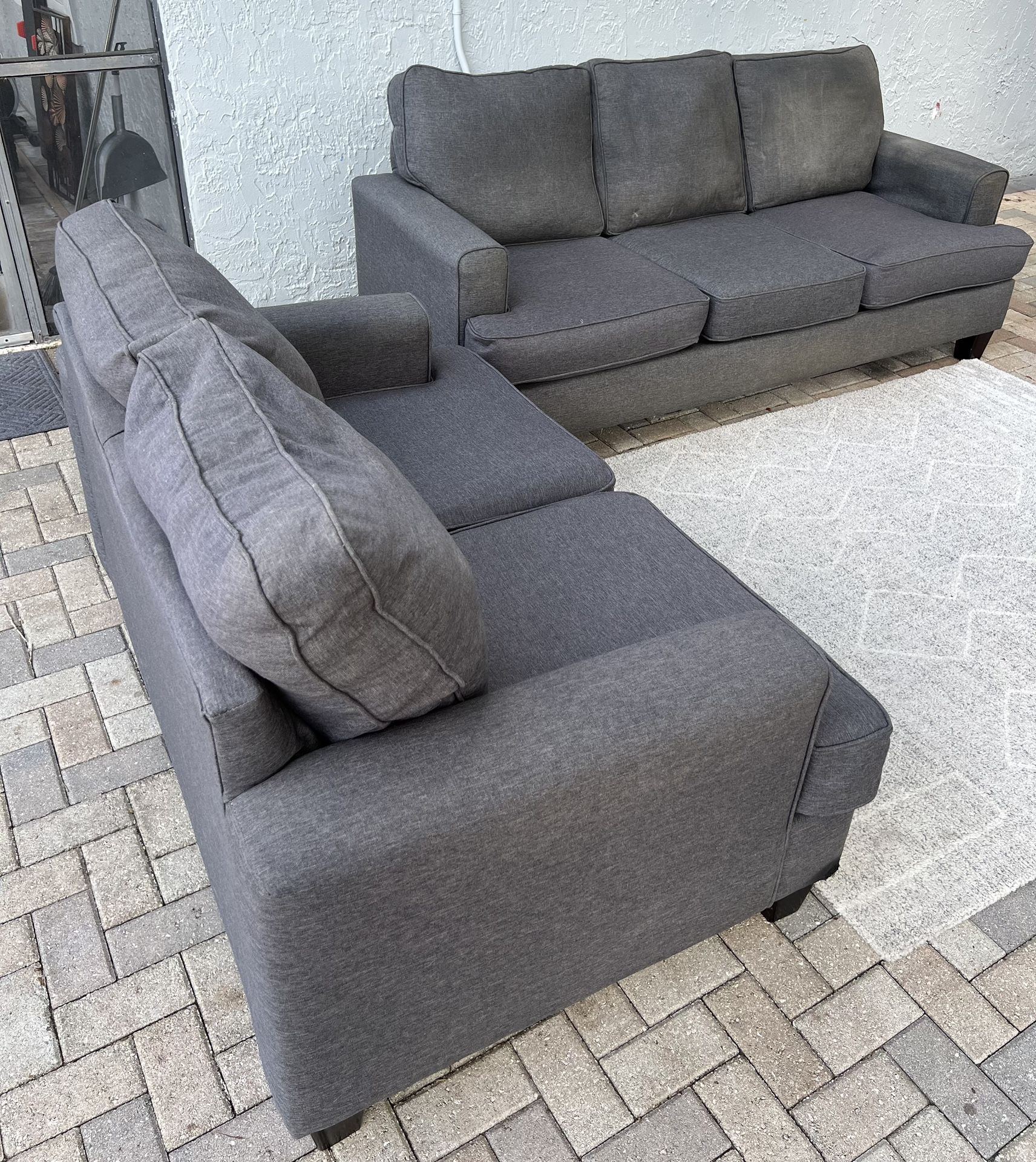 Sofa and loveseat in perfect condition.I can deliver for an additional cost.The price is $200. Dark gray color .