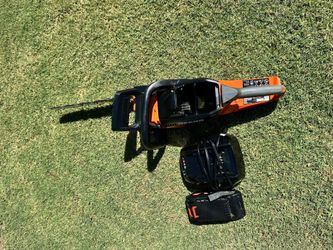 ECHO
56V 18-inch cordless electric chainsaw kit with brushless motor, rear handle, 2.5 Ah battery, and charger.
