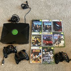 xbox with games controllers and cables