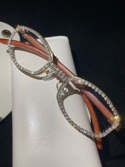 One (1) Millionaire Celebrity French Unisex wooden frame with sparkling lab, diamond ice trim. Comes with a white protective case for secure storage. 