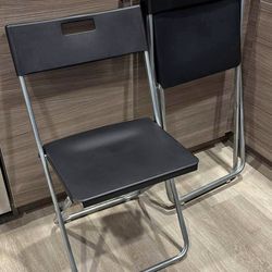 Three Ikea folding chairs
