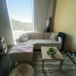 small beige sectional & coffee table