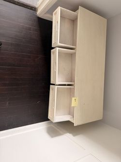 Cream Colored Table with 3 Drawers and Shelf