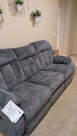 Brand new power reclining Ashley couch