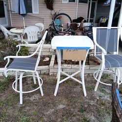 Table and two swivel chairs