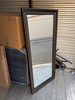 Tall dark wood mirror