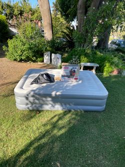 Coleman GuestRest Queen Airbed, a double-high mattress featuring a built-in 120V pump for quick inflation and deflation