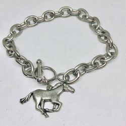 Silver tone bracelet with a horse charm