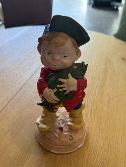 Boy Holding Fish Sculpture