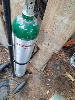 Empty.  Oxygen. Tank. With.  C a dry. Cart