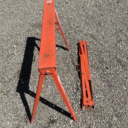 Two folding metal sawhorses