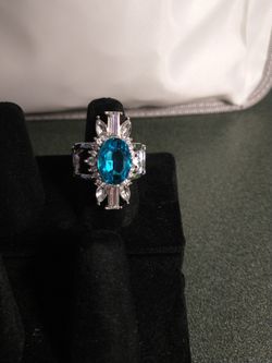 Blue Stone In The Middle Of The Ring And White Stones