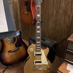 Epiphone Les Paul ProIV Electric Guitar. Gold Color/stand and Cord Included