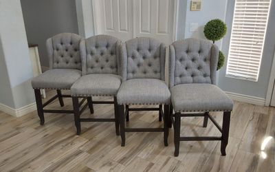 Four beautiful gray tufted counter height bar stools