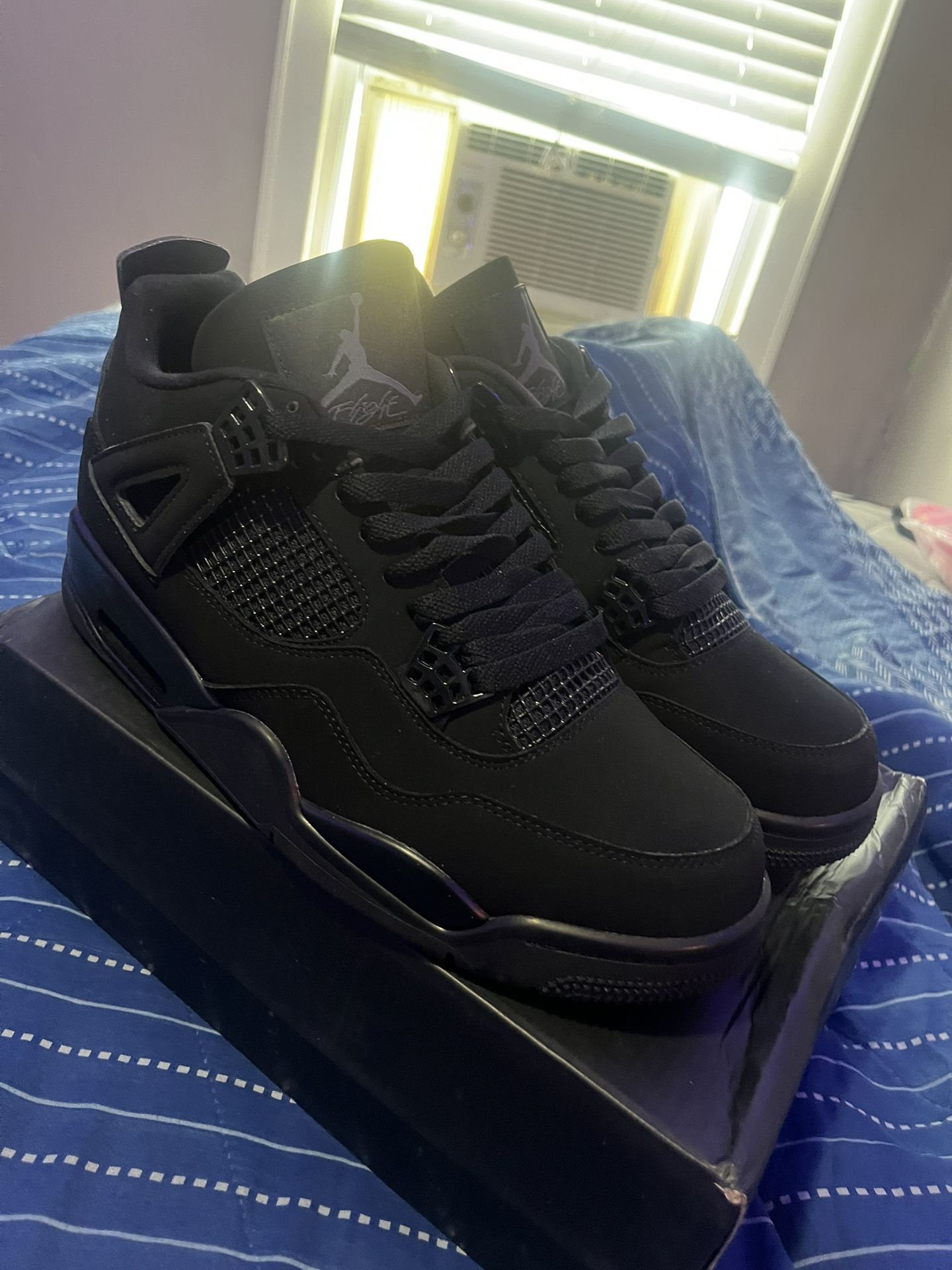 Black Cat Jordan 4s