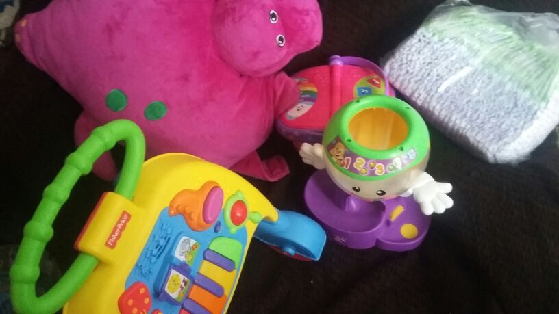 Barney pillow pet, Fisher price walker, size 4 luvs diapers, leapfrog picnic basket, Fisher price pop n play
