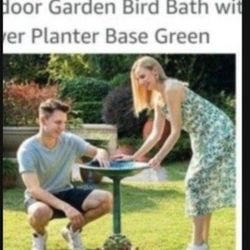 plastic fountain for bird food in the garden