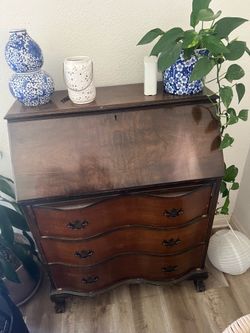 Vintage mahogany Chippendale-style secretary desk features a fall front and distinctive serpentine-shaped drawers.  Fair condition