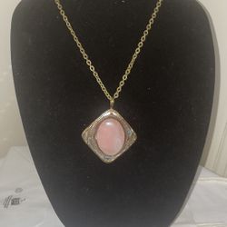 Large rose quartz set in silver, copper and brass with a gold tone 17" necklace.