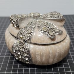 BOMBAY Bejeweled Metal Hinged Pearlized Trinket Box - Oval With Fancy Bow Design.

Very pretty piece, its strong metallic colors. 
