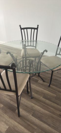 Dining table and four chairs—almost new—48 inches.