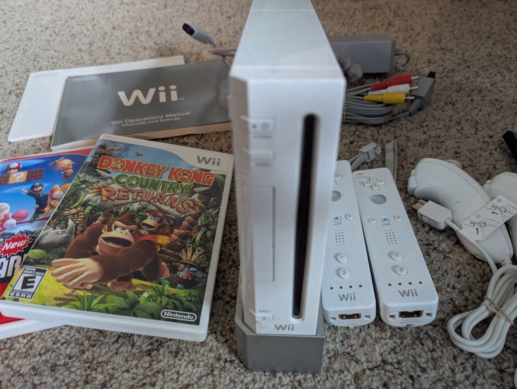 Nintendo wii console, two controllers and two nunchucks, and two incredible games
