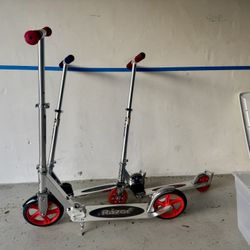 Set of 3 Razor kick Scooters. One red model A5 and 2 model A3 one red and one blue.