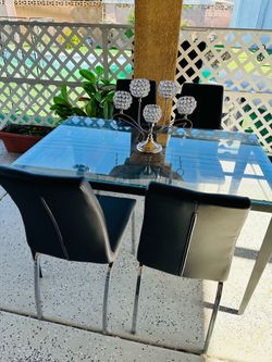 Glass dining table with chairs. Brand new.