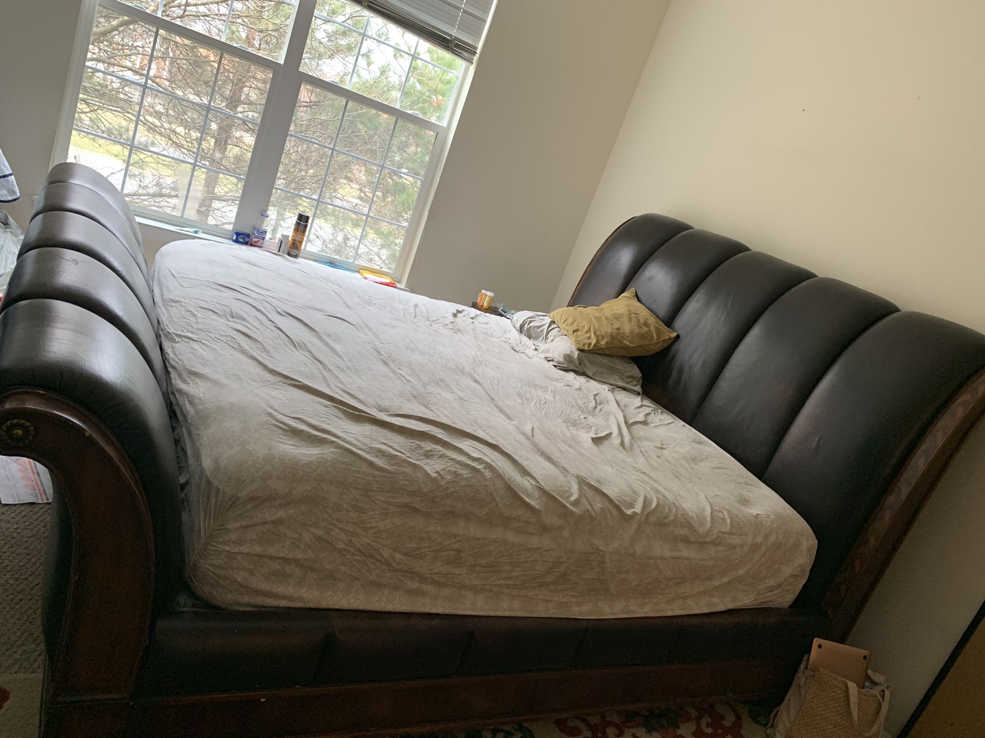 Big leather king size bed with two night stand and a drawers