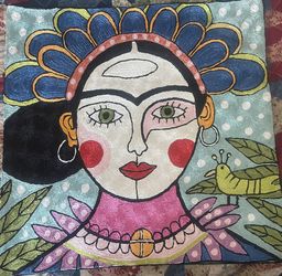 Vibrant Embroidered Artwork Featuring A Stylized Face And Bird