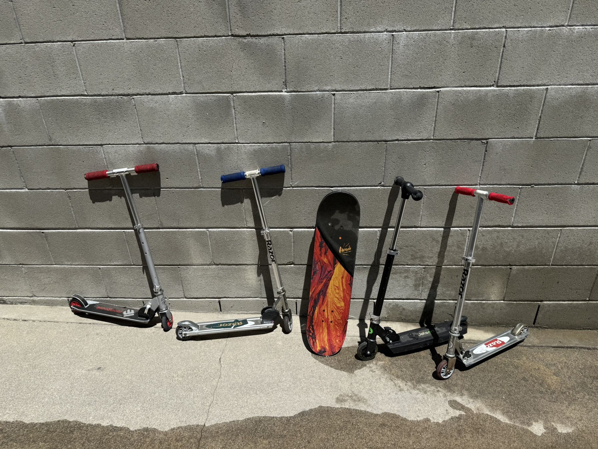 4 scooters 1 skateboard