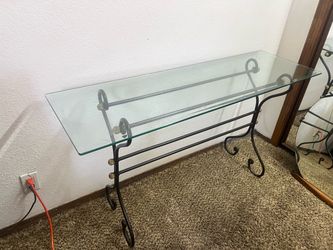 wrought iron console table with a glass