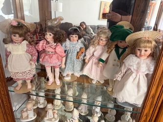 Collection of 7 Porcelain Dolls with Stands