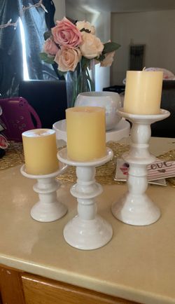 3 candle holders with candles