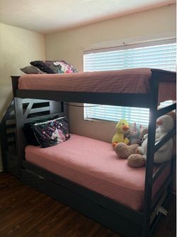 Grey twin size bunk bed with twin size trundle