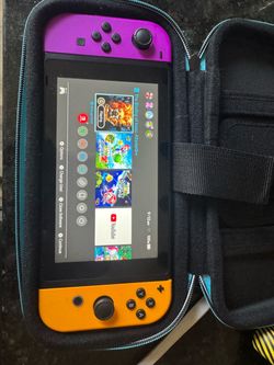 Nintendo Switch with Purple and Orange Joy-Cons and games