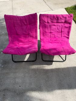 Two pink foldable chairs
