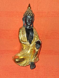 Black and gold Buddha. Five inches by one foot