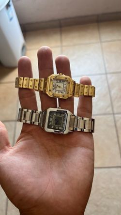 Silver men’s watch and gold women’s watch