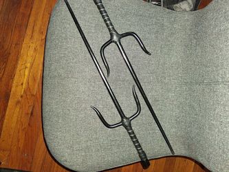 Two black metal Sai's